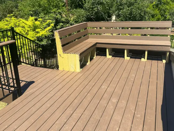 Backyard wood deck featuring built-in bench