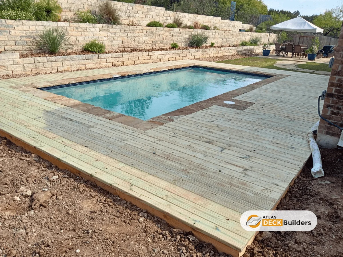 deck beside in-ground pool